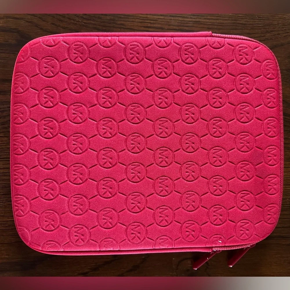 Michael Kors iPad Neoprene Sleeve Red fits iPads with up to 10.9” screens.